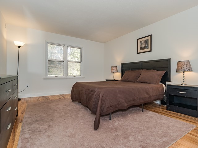Furnished Apartment North Brunswick 11A Master bedroom with large bed, dresser and nightstand